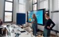 Claudia Rittel and Donata Dröge stand in front of a screen while giving a presentation on AI in journalism