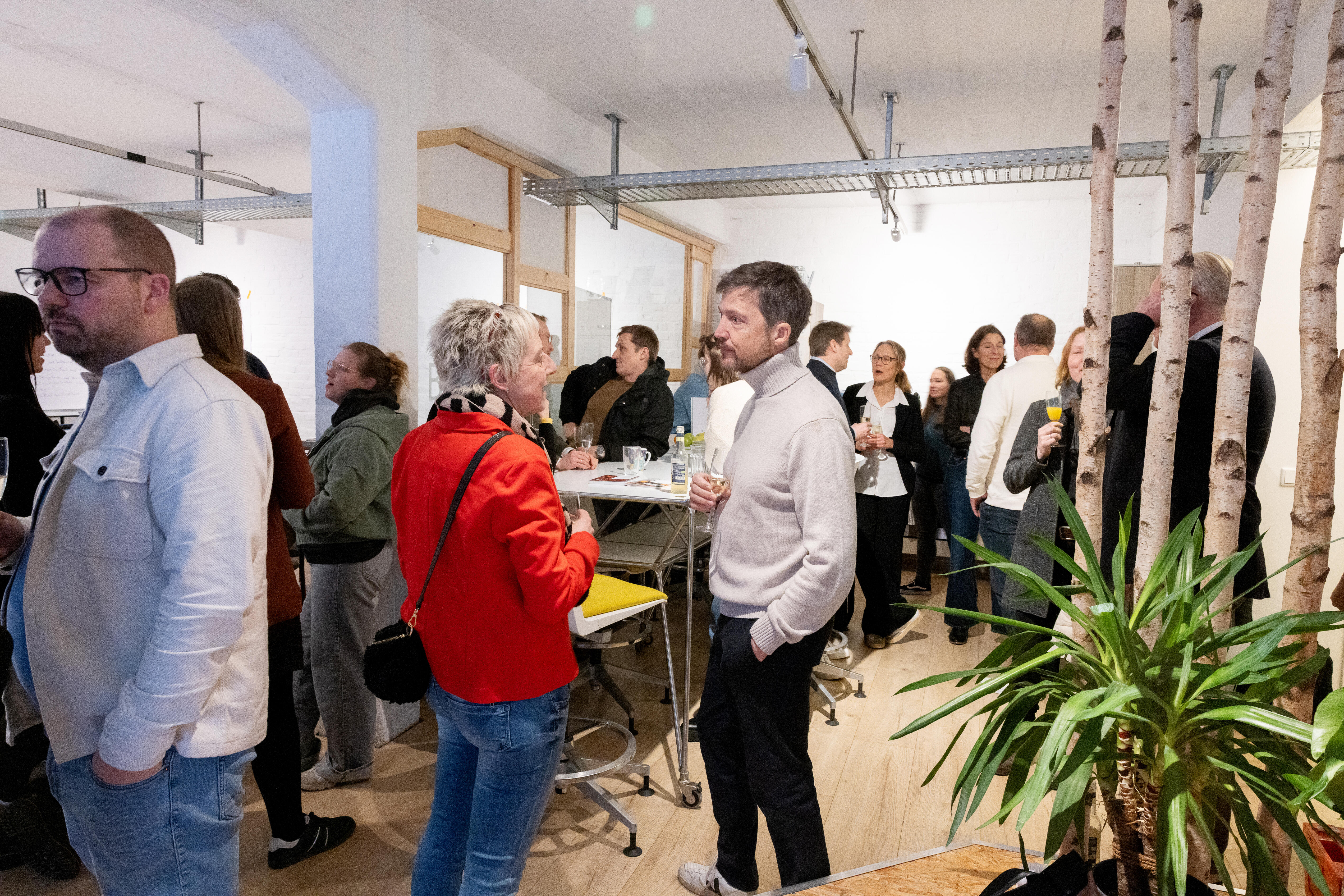 A group of people talk in a room