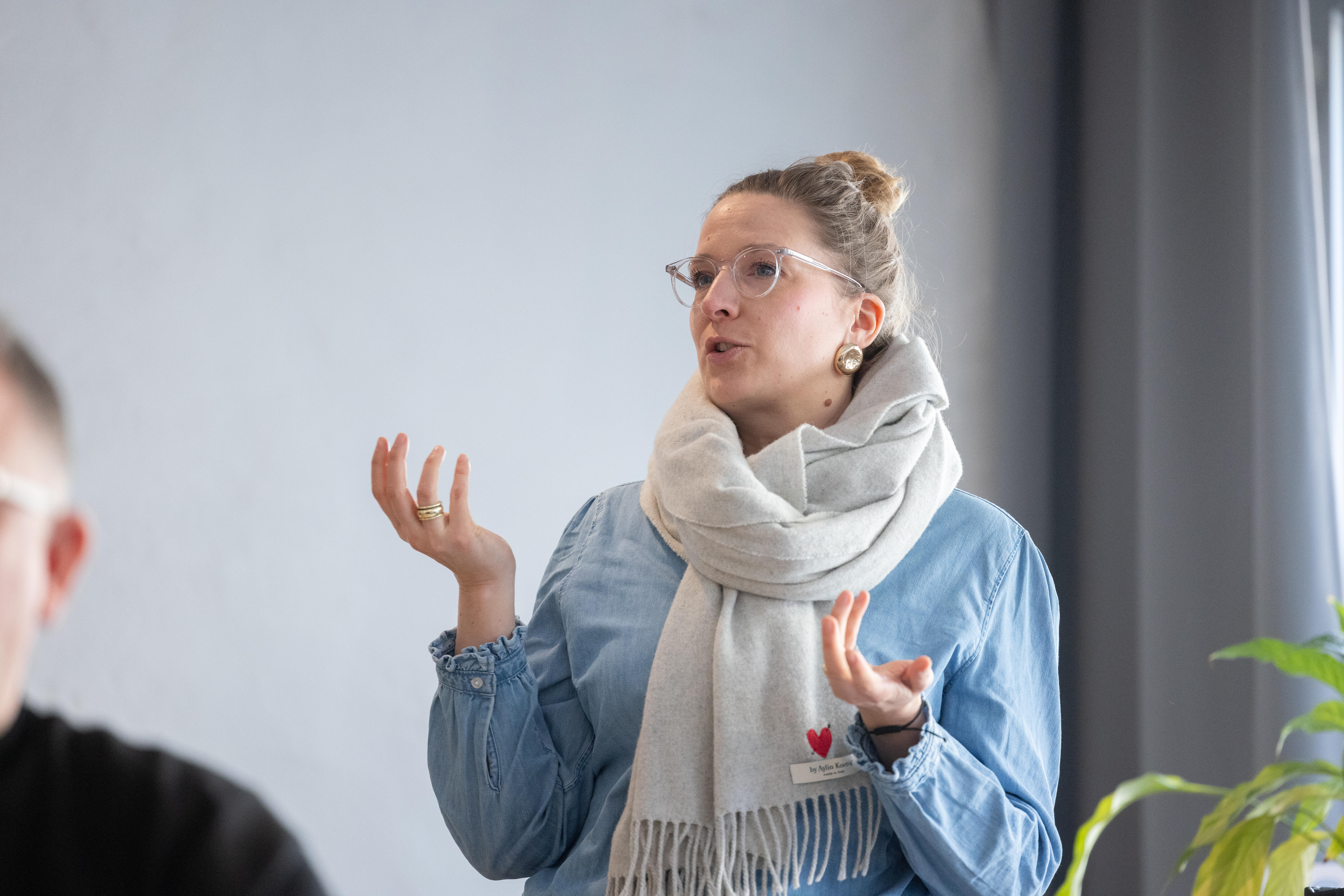 A woman gestures while standing up