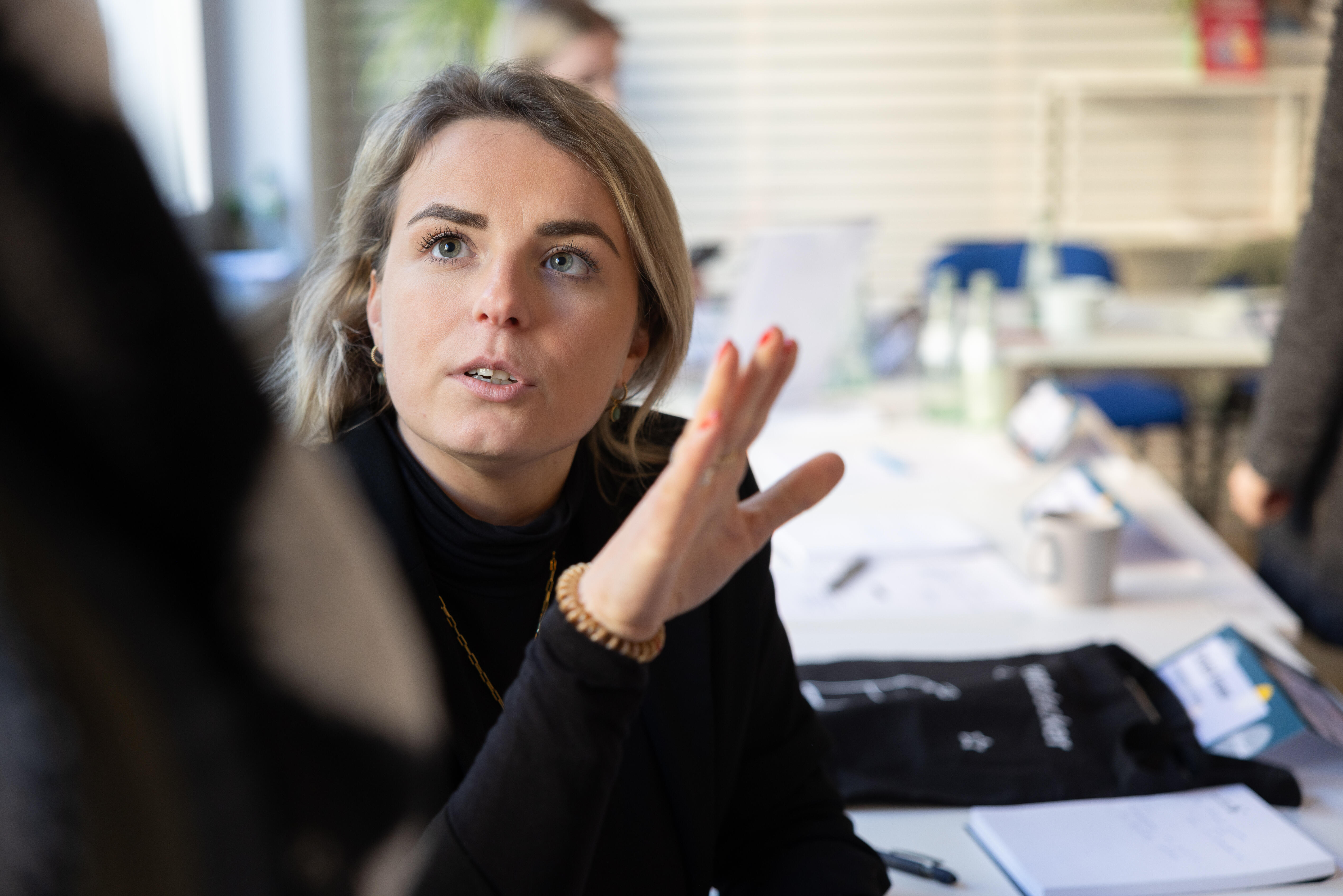 A woman gestures with her hand